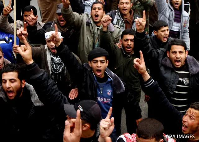 Islamic Jihad activists protest after the Friday noon prayer in support of Khader Adnan, a fellow Palestinian senior militant held in an Israeli prison without trial and who is on hunger strike since December 18, on Febr...