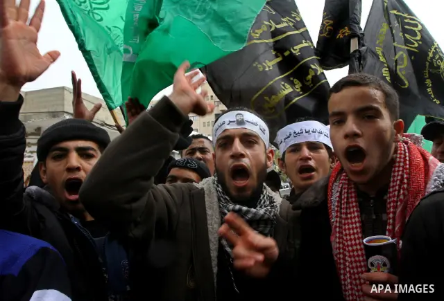 Islamic Jihad activists protest after the Friday noon prayer in support of Khader Adnan, a fellow Palestinian senior militant held in an Israeli prison without trial and who is on hunger strike since December 18, on Febr...
