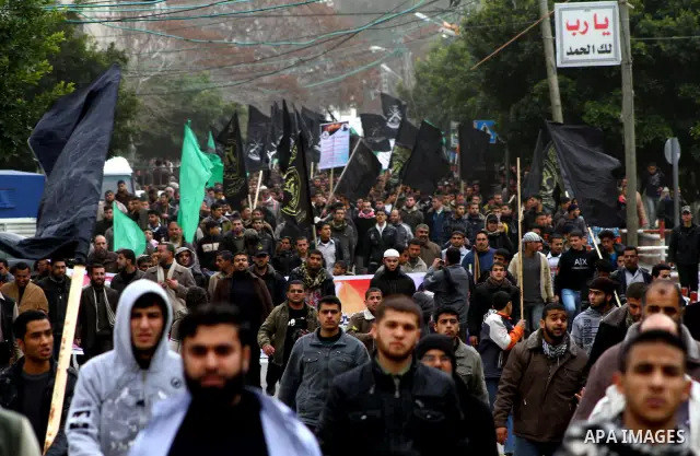 Islamic Jihad activists protest after the Friday noon prayer in support of Khader Adnan, a fellow Palestinian senior militant held in an Israeli prison without trial and who is on hunger strike since December 18, on Febr...