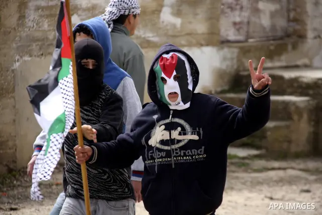 Palestinian youths hurl stones at Israeli troops during a protest in the village of Kufr Qaddum against the expansion of the nearby Jewish settlement of Kdumim, in the northern West Bank, Friday, Feb. 17, 2012. Photo by...