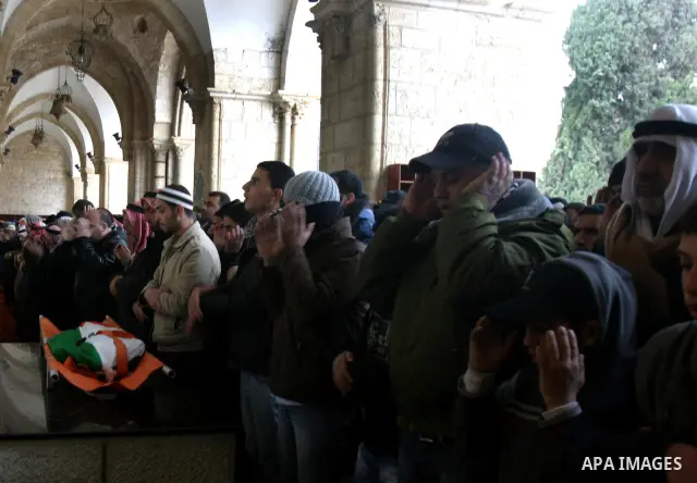 Palestinians take part in the funeral of a child, one of schoolchildren killed in a school bus accident, at Al-Aqsa mosque on Feb.17, 2012. A truck lost control in slick, rainy weather and barreled into a Palestinian sch...