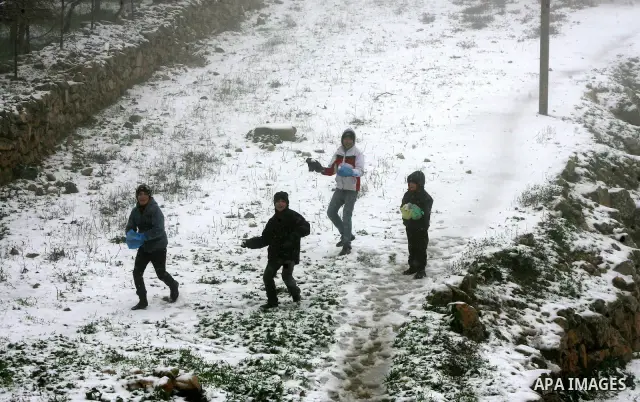 Palestinians play with snow in the West Bank city of Hebron on February 18, 2012. Photo by Mamoun Wazwaz