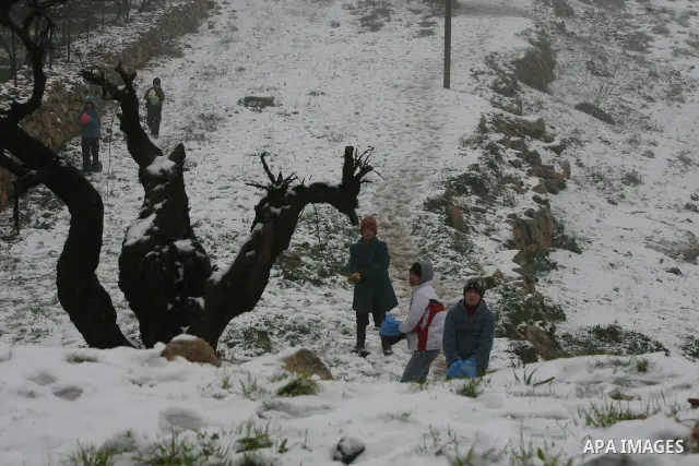 Palestinians play with snow in the West Bank city of Hebron on February 18, 2012. Photo by Mamoun Wazwaz