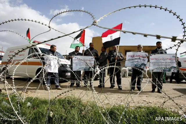 Palestinians attend a rally in front of the Rafah border crossing with Egypt on February 18, 2012 during a sit-in by dozens of emergency crews and ambulance workers demanding Egypt provide the Gaza Strip with electricity...