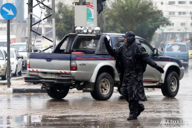 Palestinian police man organize the traffic during the heavy rain of the winter, in the Gaza City, Feb.19, 2012. Photo by Mohammed Asad