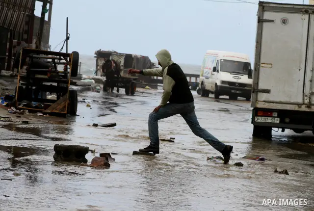 Palestinians walk in a street during the heavy rain of the winter, in the Gaza City, Feb. 19, 2012. Photo by Ashraf Amra
