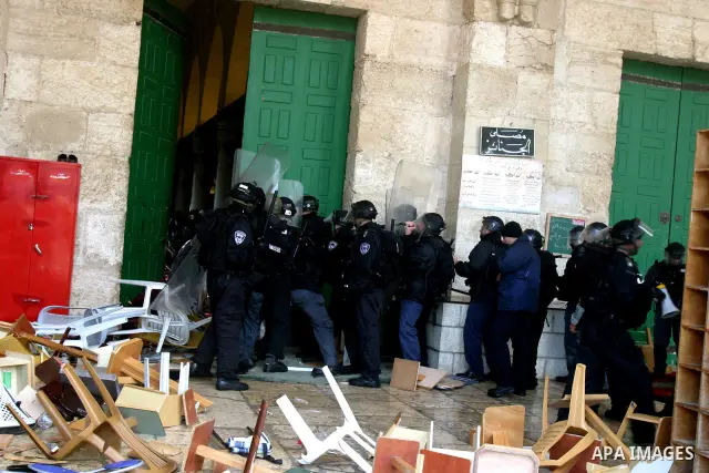 Israeli riot police at the doors to the al-Aqsa Mosque on the Hareem el-Sharif (the Noble Sanctuary), or Temple Mount, in Jerusalem, 19 February 2012, as they battle Palestinians inside during clashes. Israeli police rep...