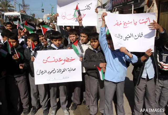 Palestinians students hold posters depicting Palestinian prisoner Khader Adnan, a member of the Islamic Jihad militant group, during a protest in front of the Red Cross in Gaza City, calling for the release of Palestinia...