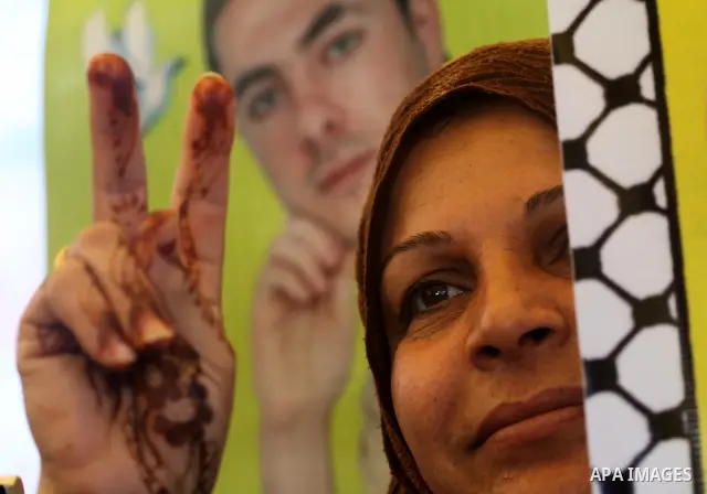 Palestinians women hold posters depicting Palestinian prisoner Khader Adnan, a member of the Islamic Jihad militant group, during a protest in front of the Red Cross in Gaza City, calling for the release of Palestinian p...