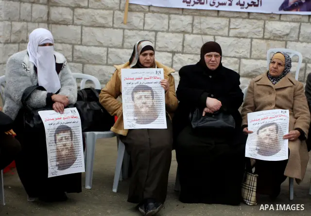 Palestinians participates in a protest in solidarity with Khader Adnan, 33, a senior member of Islamic Jihad jailed in Israel who has been on hunger strike for 65 days, and calling for the release of Palestinian prisoner...