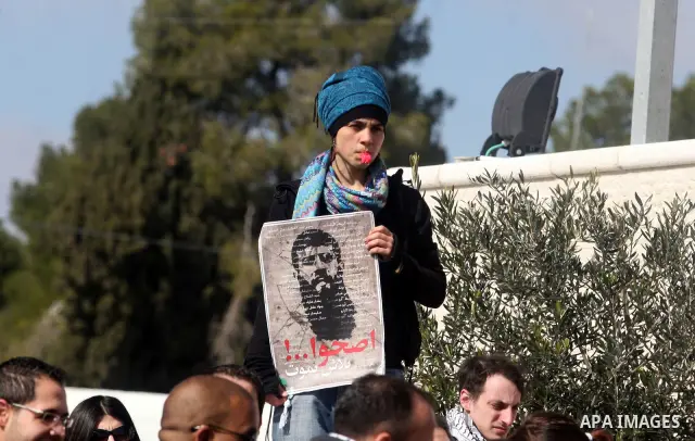 Palestinians participates in a protest in solidarity with Khader Adnan, 33, a senior member of Islamic Jihad jailed in Israel who has been on hunger strike for 65 days, and calling for the release of Palestinian prisoner...