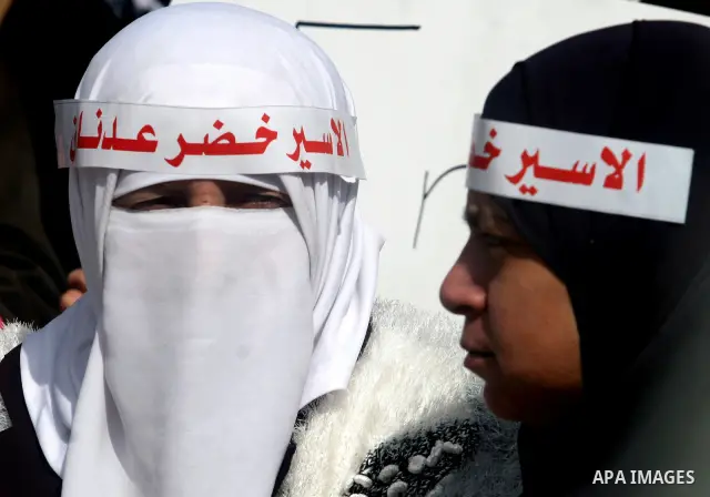 Palestinians participates in a protest in solidarity with Khader Adnan, 33, a senior member of Islamic Jihad jailed in Israel who has been on hunger strike for 65 days, and calling for the release of Palestinian prisoner...
