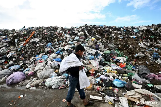 Palestinian Ahmed Mansor collects plastics and metals from a pile of waste in Jabaliya refugee camp, Gaza Strip, 19 February 2012. The United Nations Relief and Works Agency (UNRWA) states that the Israeli blockade on Ga...
