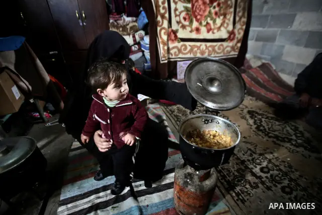 A Palestinian woman cooks inside her family home in the Jabaliya Refugee camp, Gaza Strip, 19 February 2012. The United Nations Relief and Works Agency (UNRWA) states that the Israeli blockade on Gaza has made life more...