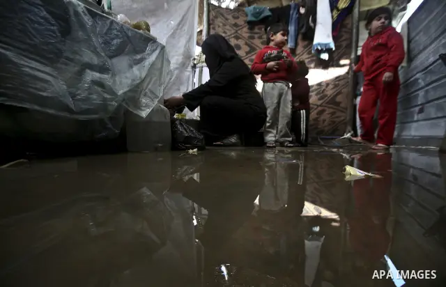 A Palestinian woman cooks inside her family home in the Jabaliya Refugee camp, Gaza Strip, 19 February 2012. The United Nations Relief and Works Agency (UNRWA) states that the Israeli blockade on Gaza has made life more...