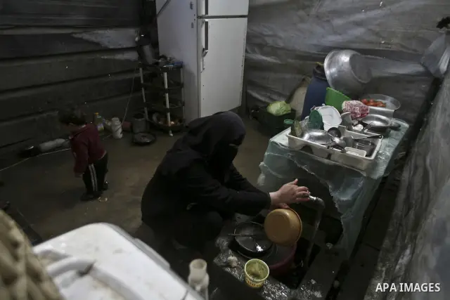A Palestinian woman cooks inside her family home in the Jabaliya Refugee camp, Gaza Strip, 19 February 2012. The United Nations Relief and Works Agency (UNRWA) states that the Israeli blockade on Gaza has made life more...