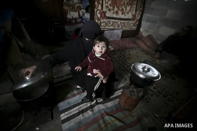 A Palestinian woman cooks inside her family home in the Jabaliya Refugee camp, Gaza Strip, 19 February 2012. The United Nations Relief and Works Agency (UNRWA) states that the Israeli blockade on Gaza has made life more...