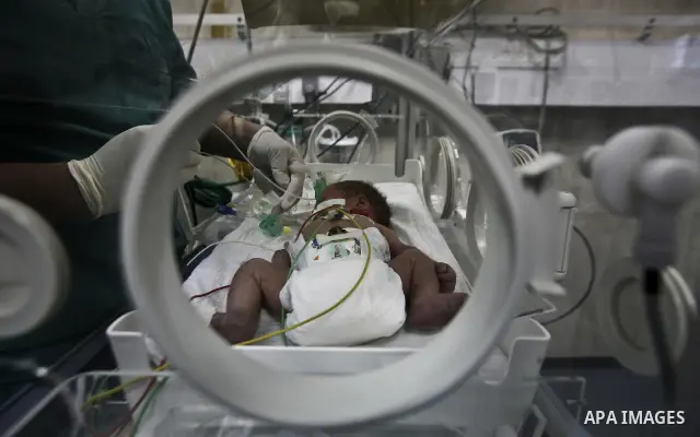 A nurse attends to a Palestinian infant in an incubator at Al-Nasser hospital in Gaza Strip on 20 February 2012. The hospital has been suffering from power cuts after the impoverished territory's sole power plant, that s...