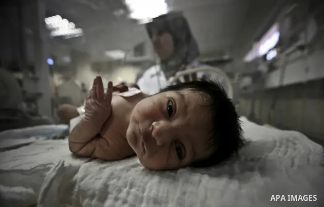 A nurse attends to a Palestinian infant in an incubator at Al-Nasser hospital in Gaza Strip on 20 February 2012. The hospital has been suffering from power cuts after the impoverished territory's sole power plant, that s...