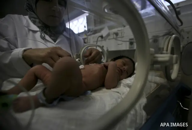 A nurse attends to a Palestinian infant in an incubator at Al-Nasser hospital in Gaza Strip on 20 February 2012. The hospital has been suffering from power cuts after the impoverished territory's sole power plant, that s...