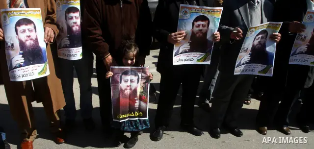 Palestinian supporters of the Islamic Jihad militant group participate in a protest in solidarity with Khader Adnan, a senior member of Islamic Jihad jailed in Israel who has been on hunger strike for 66 days, in Gaza Ci...