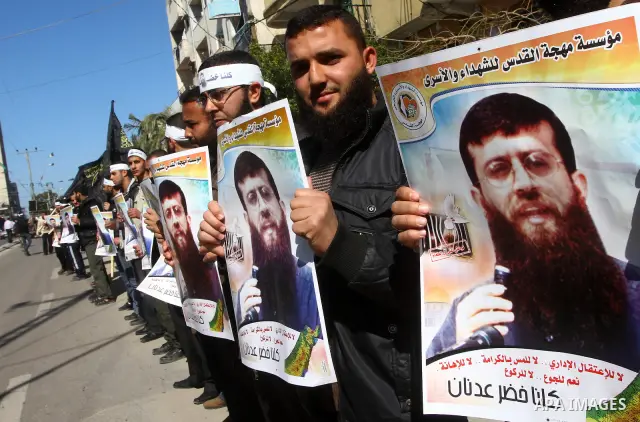 Palestinian supporters of the Islamic Jihad militant group participate in a protest in solidarity with Khader Adnan, a senior member of Islamic Jihad jailed in Israel who has been on hunger strike for 66 days, in Gaza Ci...