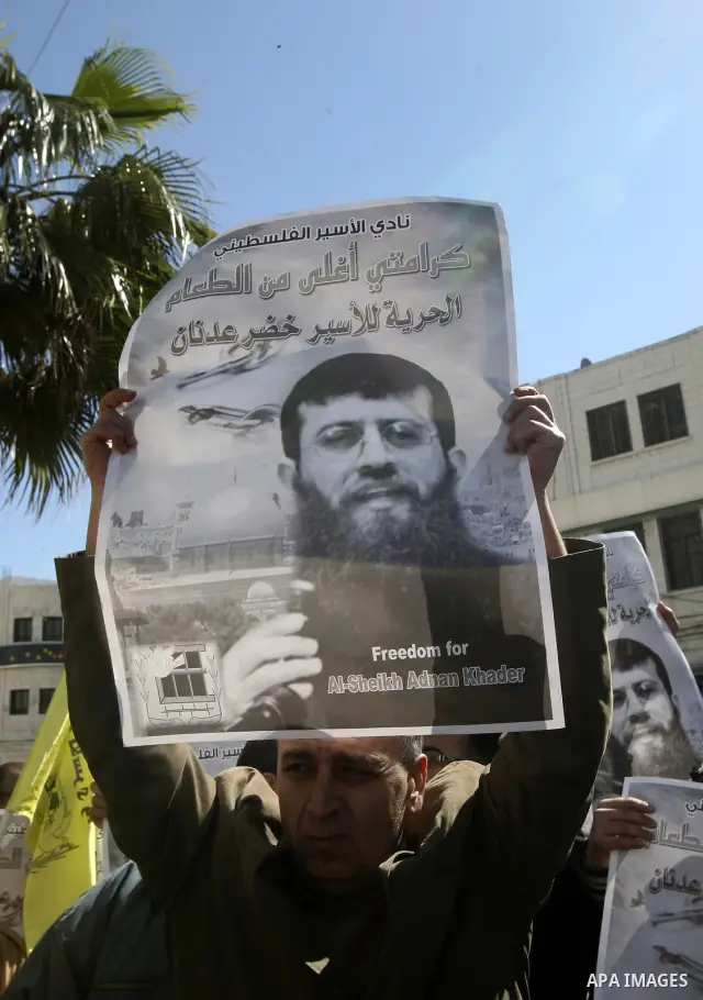 Palestinians hold posters with the images of Khader Adnan Islamic Jihad leader , who is on hunger strike to protest against his detention by Israel, during a rally supporting , in the city of Nablus West Bank , Feb 21, 2...