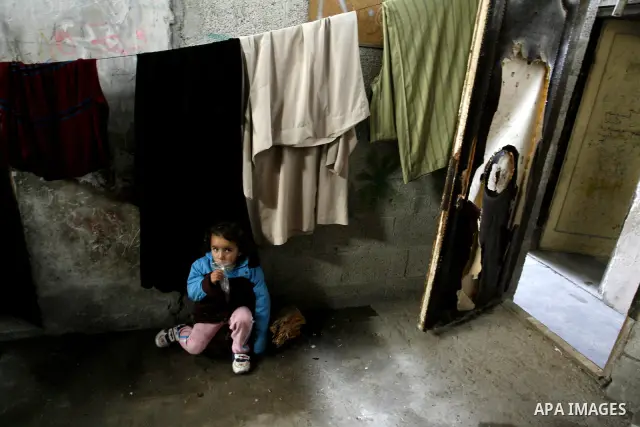 A Palestinian girl sits inside her bad-built home in Khan Younis refugee camp in southern Gaza Strip, 21 February 2012. The United Nations Relief and Works Agency (UNRWA) stated that the Israeli blockade on Gaza has made...