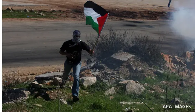 A Palestinian protester throws a stone towards Israeli troops during clashes outside Ofer prison near the West Bank city of Ramallah February 21, 2012. The clashes broke out after a protest in support of Islamic Jihad me...