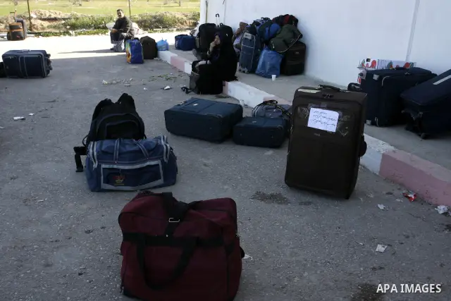 Palestinians wait to cross the Rafah border crossing in the southern Gaza Strip into Egypt on Feb. 22, 2012. Maher Abu Sabha, Director General of the crossings in the Gaza government resign from office an Interior Minist...