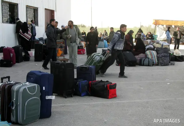Palestinians wait to cross the Rafah border crossing in the southern Gaza Strip into Egypt on Feb. 22, 2012. Maher Abu Sabha, Director General of the crossings in the Gaza government resign from office an Interior Minist...