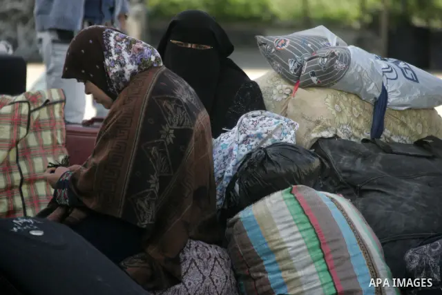 Palestinians wait to cross the Rafah border crossing in the southern Gaza Strip into Egypt on Feb. 22, 2012. Maher Abu Sabha, Director General of the crossings in the Gaza government resign from office an Interior Minist...