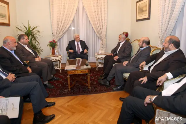 Palestinian President Mahmud Abbas meets with Palestinian prime minister in Gaza Strip, Ismail Haniya in Cairo on February 23,2012, to implement the terms of a reconciliation deal they signed in the Egyptian capital in M...