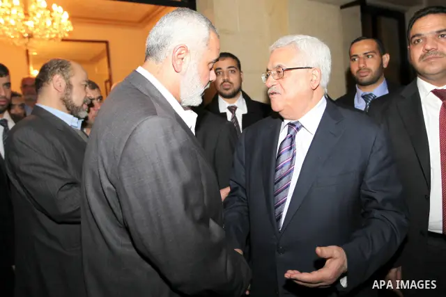 Palestinian President Mahmud Abbas meets with Palestinian prime minister in Gaza Strip, Ismail Haniya in Cairo on February 23,2012, to implement the terms of a reconciliation deal they signed in the Egyptian capital in M...