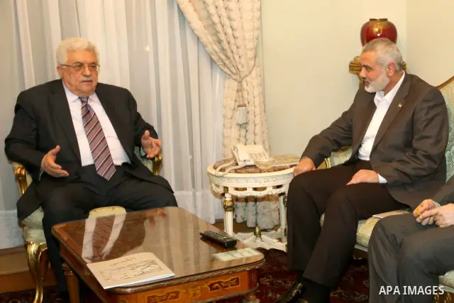 Palestinian President Mahmud Abbas meets with Palestinian prime minister in Gaza Strip, Ismail Haniya in Cairo on February 23,2012, to implement the terms of a reconciliation deal they signed in the Egyptian capital in M...