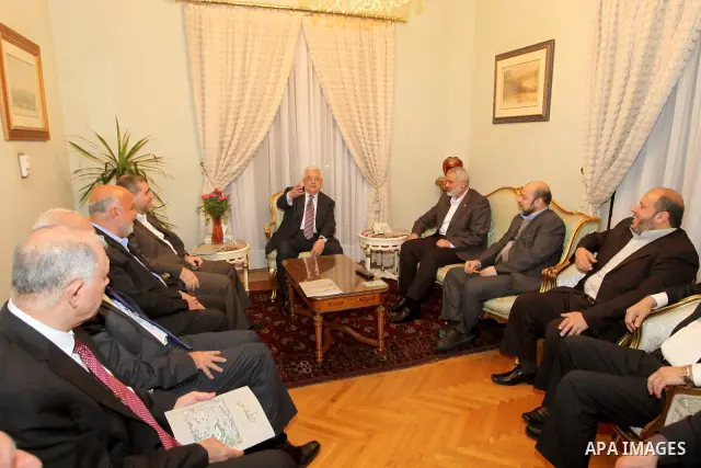 Palestinian President Mahmud Abbas meets with Palestinian prime minister in Gaza Strip, Ismail Haniya in Cairo on February 23,2012, to implement the terms of a reconciliation deal they signed in the Egyptian capital in M...