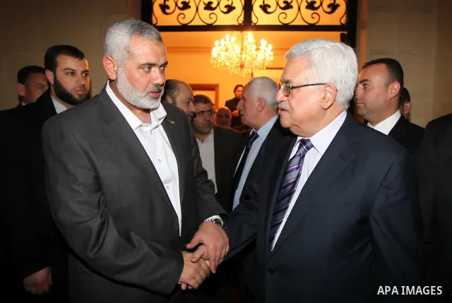 Palestinian President Mahmud Abbas meets with Palestinian prime minister in Gaza Strip, Ismail Haniya in Cairo on February 23,2012, to implement the terms of a reconciliation deal they signed in the Egyptian capital in M...