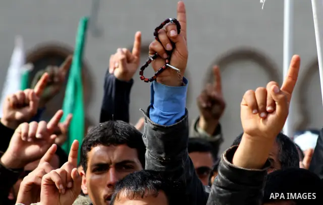 Palestinian protesters shout slogans as they gather in Khan Yunis in the southern Gaza Strip on February 24, 2012 during a demonstration to show solidarity for Jerusalem's Al-Aqsa mosque compound. Clashes briefly broke o...