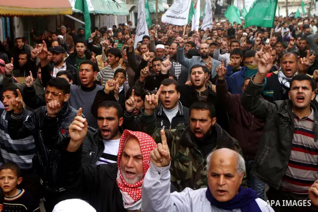 Palestinian protesters shout slogans as they gather in Khan Yunis in the southern Gaza Strip on February 24, 2012 during a demonstration to show solidarity for Jerusalem's Al-Aqsa mosque compound. Clashes briefly broke o...