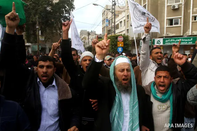 Palestinian protesters shout slogans as they gather in Khan Yunis in the southern Gaza Strip on February 24, 2012 during a demonstration to show solidarity for Jerusalem's Al-Aqsa mosque compound. Clashes briefly broke o...