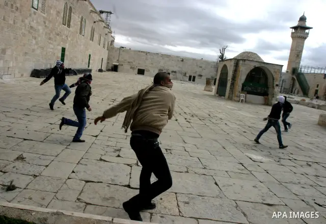 Palestinian protesters hurl stones during clashes with Israeli policemen on the compound known to Muslims as the Noble Sanctuary and to Jews as the Temple Mount in Jerusalem's Old City February 24, 2012. Israeli policeme...