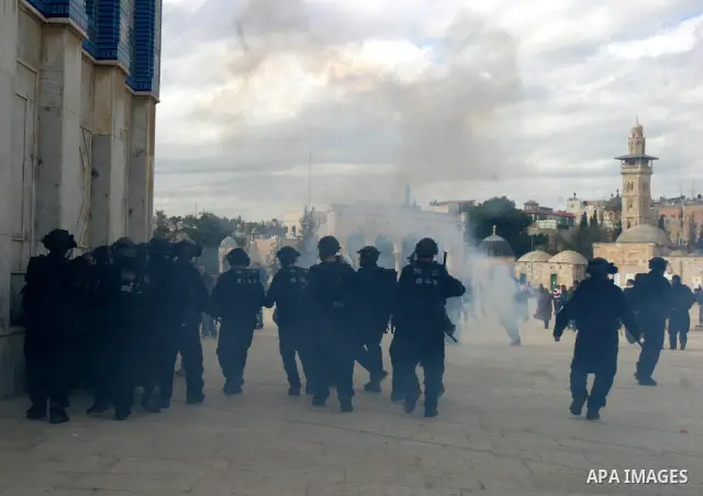 Israeli policemen shoot tear gas and throw stun grenades during clashes with Palestinian protesters on the compound known to Muslims as the Noble Sanctuary and to Jews as the Temple Mount in Jerusalem's Old City February...