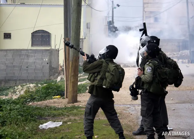 Palestinian protesters clash with Israeli soldiers during a demonstration against the expropriation of Palestinian land by Israel in the village of Kfar Qaddum, near the West Bank city of Nablus, on February 24, 2012. Ph...