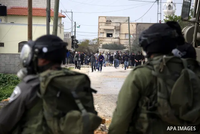 Palestinian protesters clash with Israeli soldiers during a demonstration against the expropriation of Palestinian land by Israel in the village of Kfar Qaddum, near the West Bank city of Nablus, on February 24, 2012. Ph...