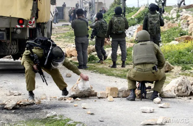 Palestinian protesters clash with Israeli soldiers during a demonstration against the expropriation of Palestinian land by Israel in the village of Kfar Qaddum, near the West Bank city of Nablus, on February 24, 2012. Ph...
