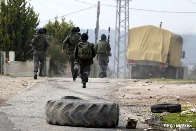 Palestinian protesters clash with Israeli soldiers during a demonstration against the expropriation of Palestinian land by Israel in the village of Kfar Qaddum, near the West Bank city of Nablus, on February 24, 2012. Ph...