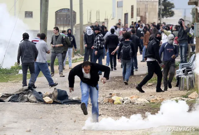 Palestinian protesters throw stones at Israeli soldiers during a demonstration against the expropriation of Palestinian land by Israel in the village of Kfar Qaddum, near the West Bank city of Nablus, on February 24, 201...