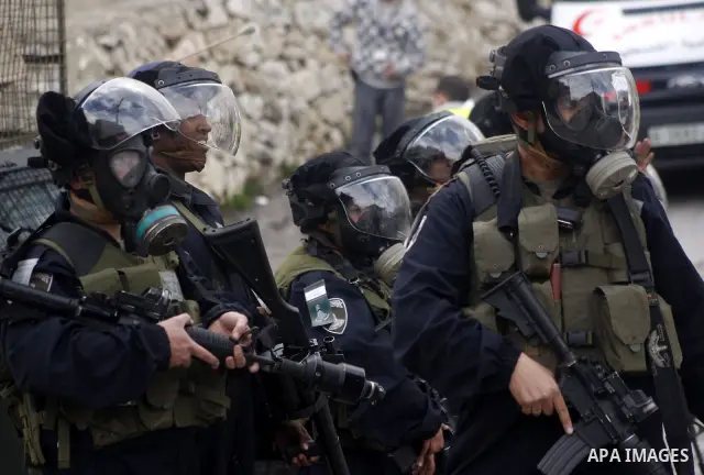 Israeli policemen stand guards during clashes with Palestinian protesters at a demonstration against the closure of Shuhada street to Palestinians, in the West Bank city of Hebron February 24, 2012. Some 200 protesters,...