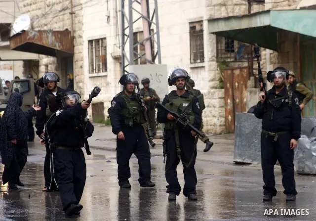 Israeli policemen stand guards during clashes with Palestinian protesters at a demonstration against the closure of Shuhada street to Palestinians, in the West Bank city of Hebron February 24, 2012. Some 200 protesters,...