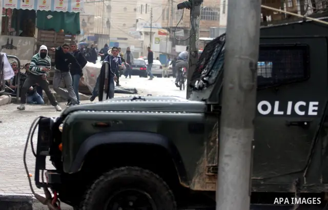 Palestinians protesters clash with Israeli soldiers during a demonstration commemorating 18 years to the Hebron massacre and calling to open Shuhada street in the West Bank city of Hebron, Friday, Feb. 24, 2012. In 1994,...